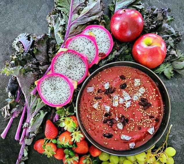 Red smoothie bowl with camelina
